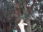 shirtless near a large tree