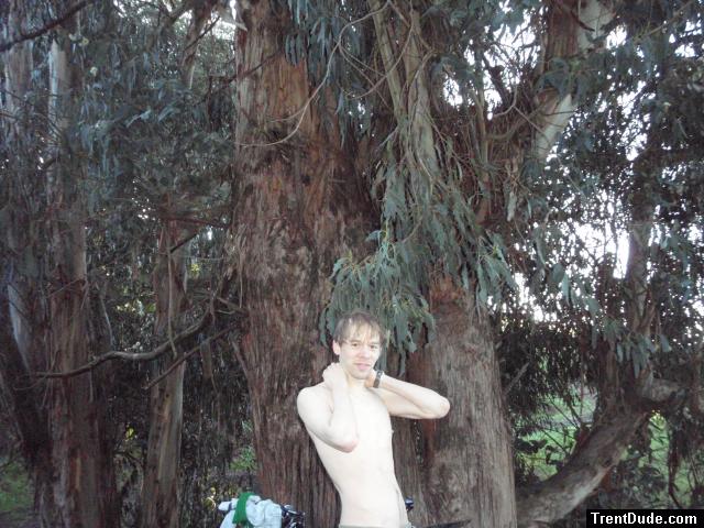shirtless near a large tree