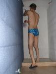 Showering after swimming in a blue swim brief