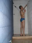 Showering after swimming in a blue swim brief