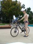 Swim dude all set to go on a mini triathlon - with a full suspension Specialized bicycle,  kickboard, Speedo Vanquisher goggles,