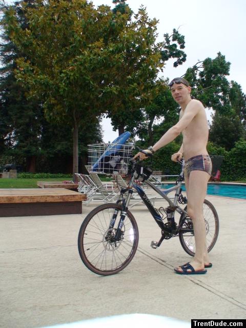 Swim dude all set to go on a mini triathlon - with a full suspension Specialized bicycle,  kickboard, Speedo Vanquisher goggles,