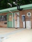 A dude on a pay phone in a swim brief