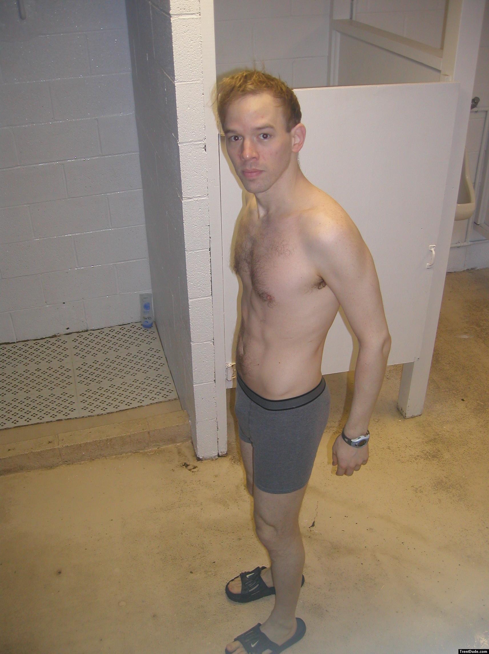 A hairy chest in grey boxer briefs, Nike slippers