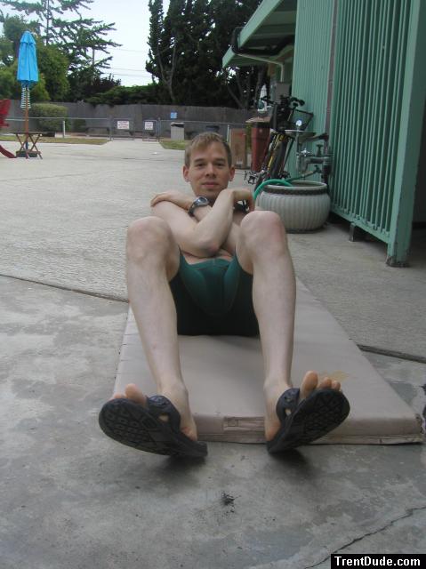 Crunches in a Nike swim jammer, toes in Nike slippers (pouch)