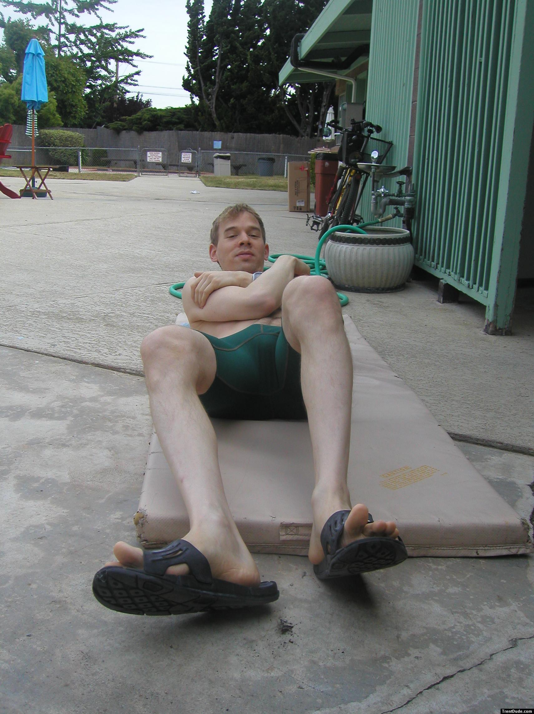 Crunches in a Nike swim jammer, toes in Nike slippers (pouch)