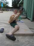 Stretching his foot (nike slippers, nike swim jammer)