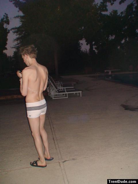 checking his phone before a morning swim (white Speedo Engineered Stripe Square Cut suit) (rear)