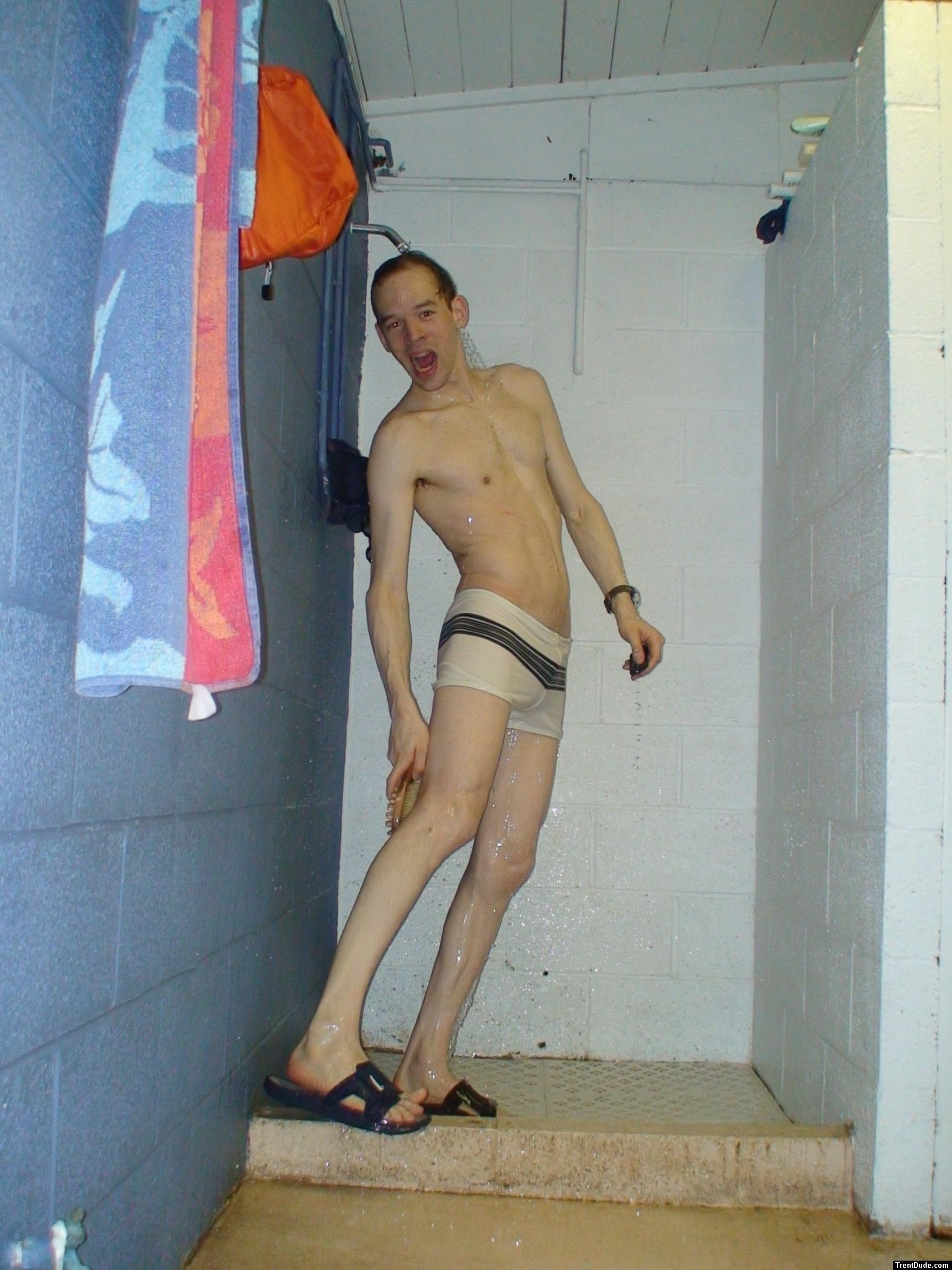 Reaching back to scrub his legs, white speedo square leg suit