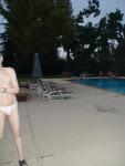 Embarrased to have his whole body seen in a white Speedo