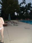 Embarrased to have his whole body seen in a white Speedo