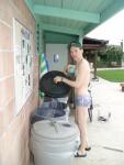 putting out the trash in a Pirates swimsuit by designer Ami Sanzuri