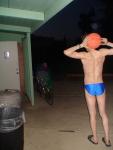 Swimmer in a blue speedo (back muscles), with basketball