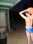 Swimmer in a blue speedo (back), with basketball