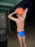 Swimmer in a blue speedo (back muscles, neck), with basketball