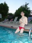 Water polo Dude in a red speedo (wearing a swimp3 to listen to podcasts while swimming)