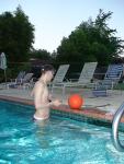 in the pool wearing a red speedo