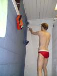 Showering in a red speedo