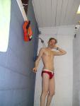 Showering in a red Speedo