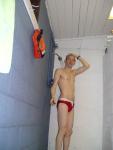 Showering in a red Speedo