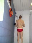 Showering in a red Speedo