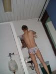 back side of the Love Letter swim brief (applying swim lotion to back)