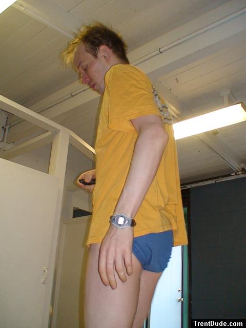 dude wearing a Blue Patagonia brief in the swim locker room (rear)