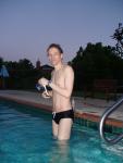 about to swim, holding a swim cap and anti-chlorine lotion (best)