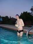 Wearing swim cap, black speedo
