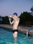 Putting goggles on before a morning swim, black speedo