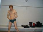Swimmer in the locker room before a swim (Nike green speedo swim brief)  (pouch)