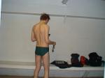 Swimmer in the locker room before a swim (Nike green speedo swim brief) best (rear)