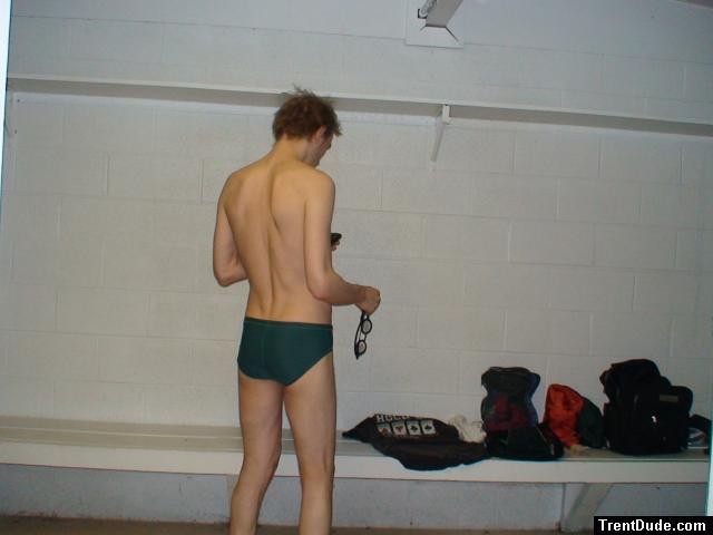Swimmer in the locker room before a swim (Nike green speedo swim brief) best (rear)