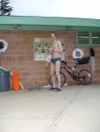 Standing near the bike in a Nike speedo