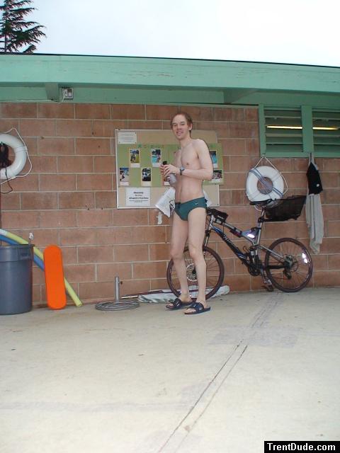 Standing near the bike in a Nike speedo