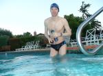 wearing a Nike black/blue speedo swim brief (unshaven)