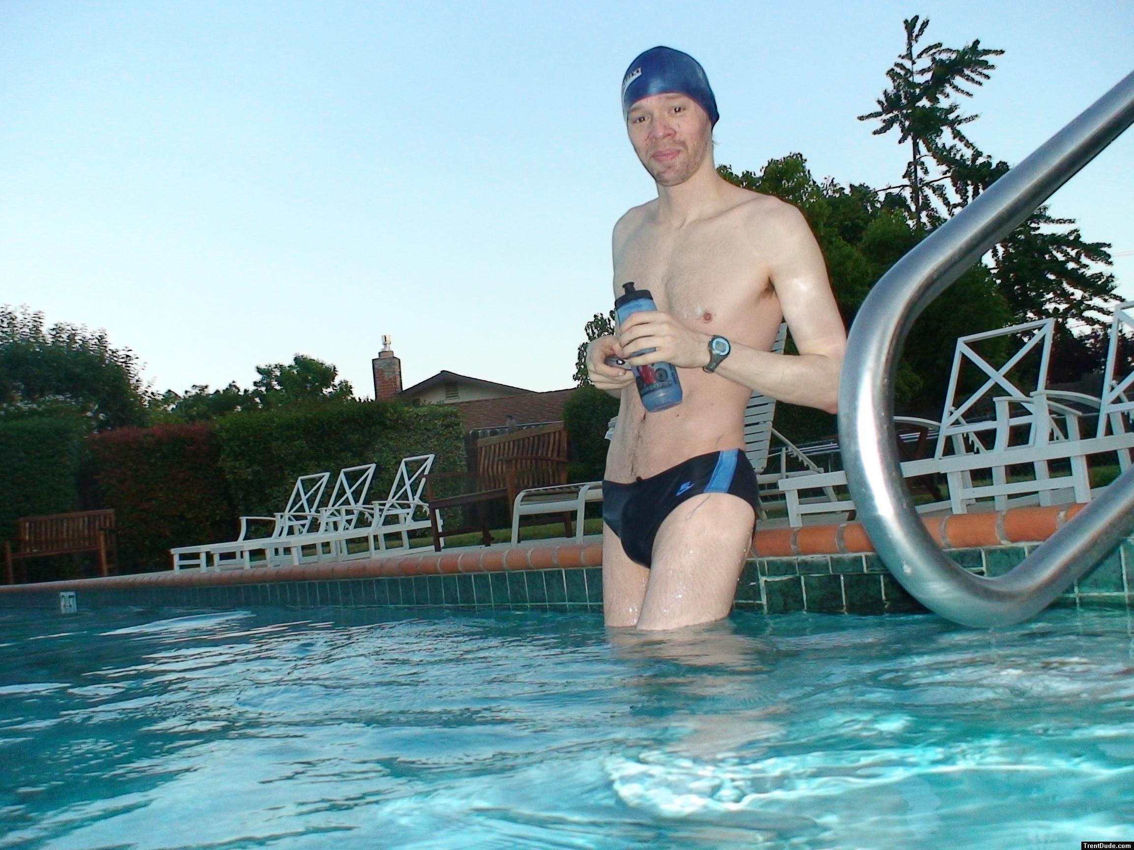 wearing a Nike black/blue speedo swim brief (unshaven)