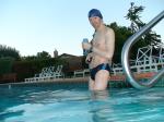 wearing a Nike black/blue speedo swim brief (pouch)