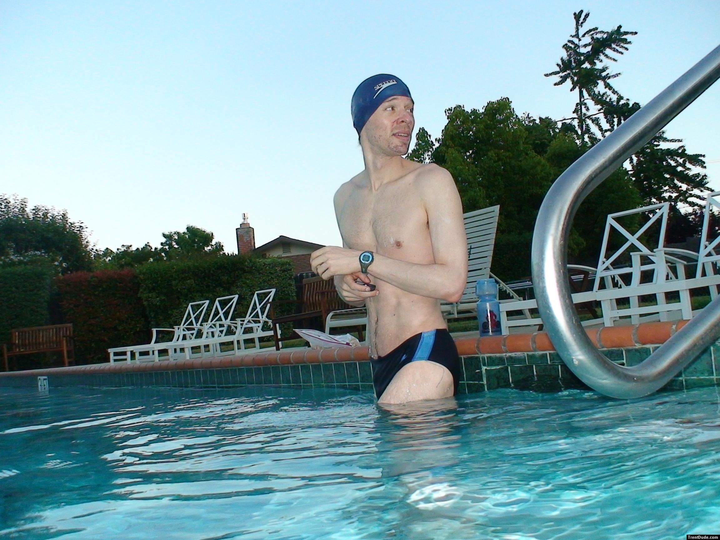 wearing a Nike black/blue speedo swim brief (unshaven)