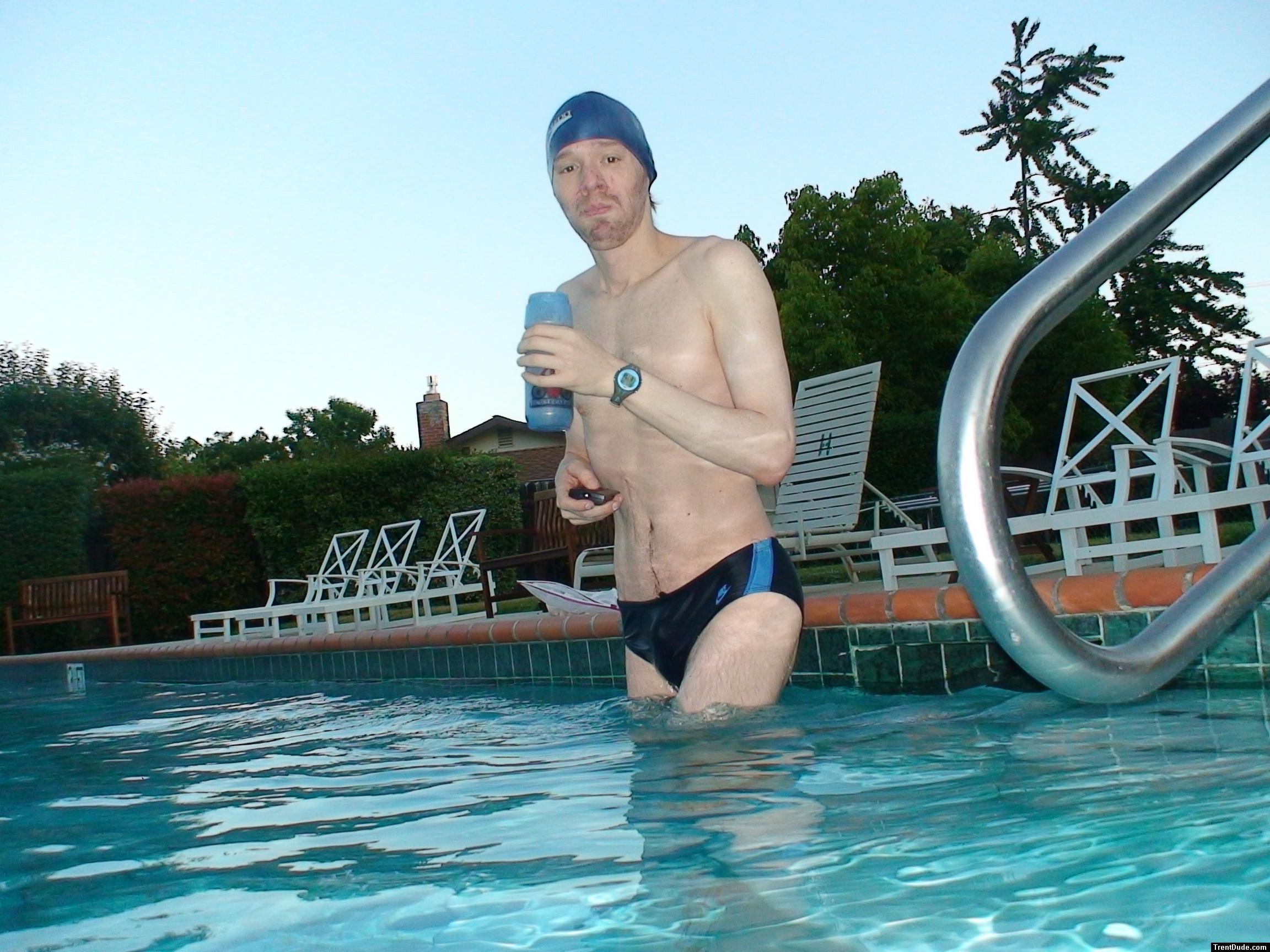 wearing a Nike black/blue speedo swim brief (unshaven)