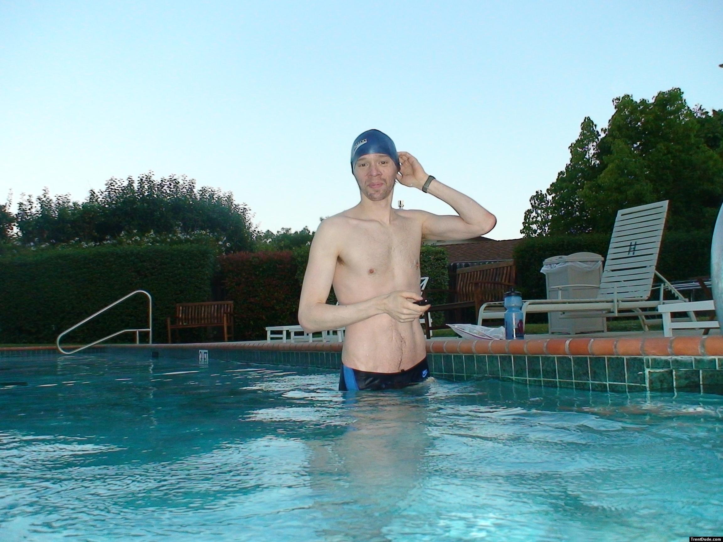 wearing a Nike black/blue speedo swim brief (unshaven)