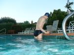 wearing a Nike black/blue speedo swim brief (rear)