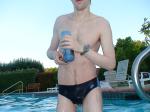 closeup, wearing a Nike black/blue speedo swim brief, water falling off suit