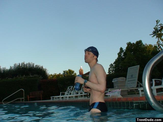 wearing a Nike black/blue speedo swim brief, gulping down an antioxidan smoothie