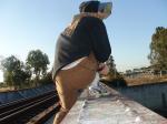Brown sweats (rear), calvin klein hip brief white underwear, on a train tressle bridge