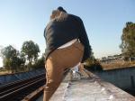 Brown sweats, calvin klein hip brief underwear underwear, on a train tressle bridge (rear)