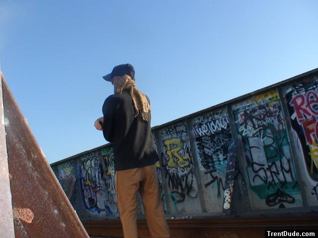 Brown sweats on train trestle, Oregon Research Helios sun hat, Christian Dior Monsieur Cashmere scarf (rear)