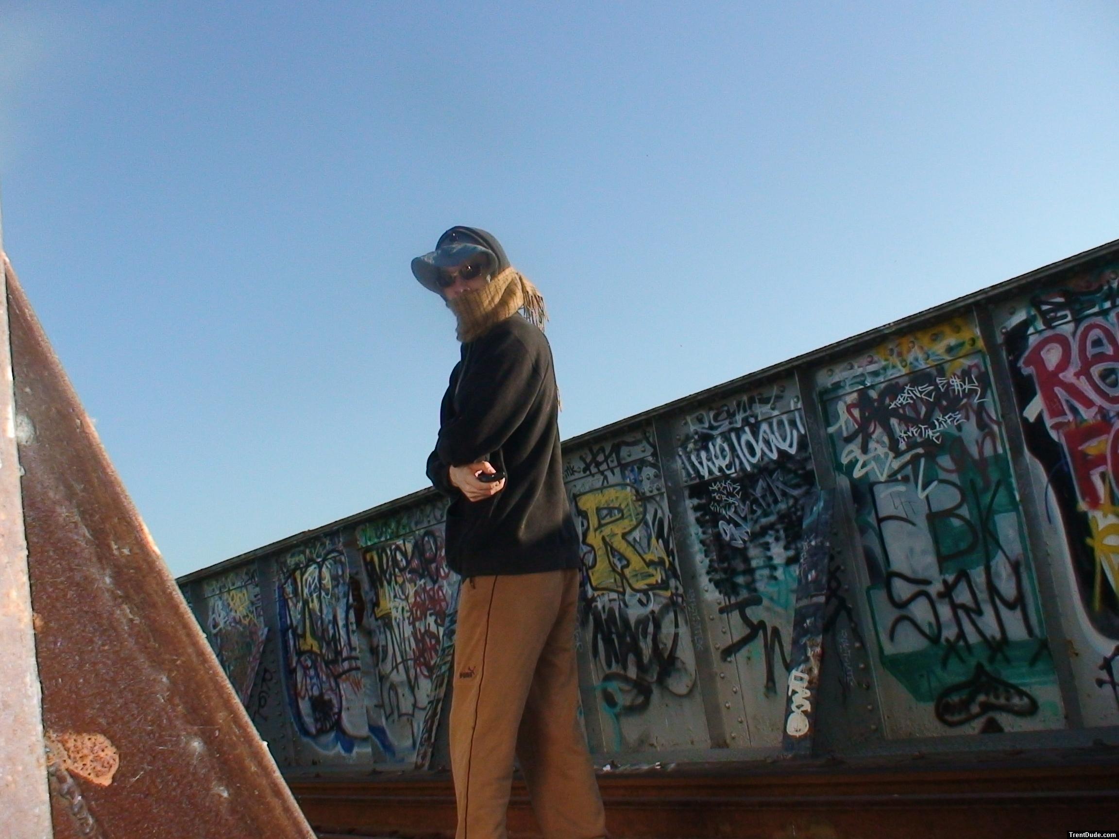 Brown sweats on train trestle, Oregon Research Helios sun hat, Christian Dior Monsieur Cashmere scarf
