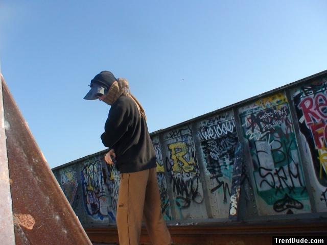 Brown sweats near lots of graffiti