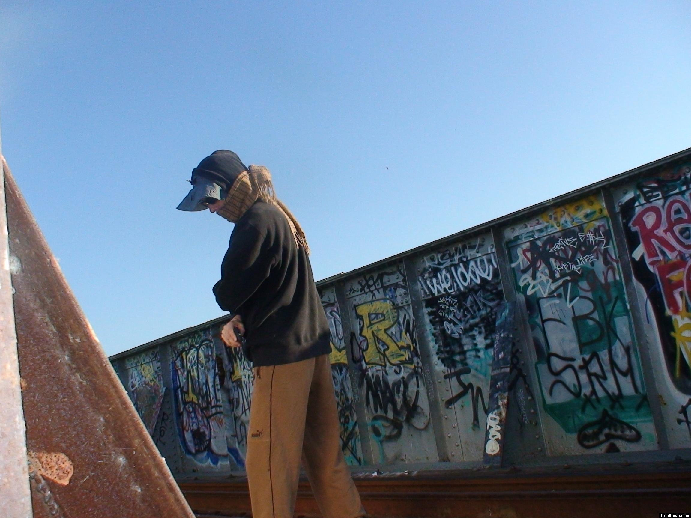 Brown sweats near lots of graffiti